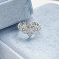 Macro shot of silver snowflake open ring with blue stone in blue velvet box - Layered Snowflake Style (JZ0076A)