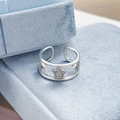 Detail of silver open ring featuring a sparkling star motif on a light blue velvet box - Hollow Double Ring Pentagram Style (JZ3409A)