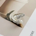 Detail of silver open ring with pavé zircons and white pearls on magazine background - Adjustable Open / Artificial Pearl Pavé Rhinestone Style (JZ5697)