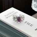 Detail of silver textured ring with oval purple gemstone and side pearls on a book - Adjustable Open / Vintage Pleated Oval Purple Stone Pearl Style (JZ1107A)