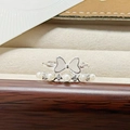 Macro detail of silver-tone enamel bow ring paired with a sparkling pearl band set - Bow And Pearl Combo Style (JZ2522A)