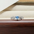 Macro shot of silver ring with heart-shaped blue zircon and side stone inlay detail - Blue Heart Gem Style (JZ5748)