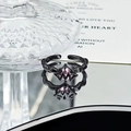 Macro shot of gothic black alloy ring with purple crystal and adjustable open band - Wave Pink Purple Gem Style (JZ3411)