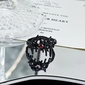 Macro detail of gothic thorn ring in black finish with a ruby red gemstone accent - Black Thorn Red Gem Style (JZ4401)