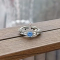 Macro shot of silver crown ring featuring a blue gemstone and white zircon accents - Crown Design Style (JZ4605)