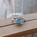 Macro detail of cat-ear silver ring with round blue gemstone and textured band - Cat Design Style (JZ4850)