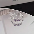 Macro shot of silver bow ring with purple cubic zirconia and twisted rope band - Twist Rope Purple Zircon Bowknot Style (JZ0543A)