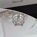 Macro view of adjustable silver bow ring featuring micro-pave sparkling zircon stones - Minimalist Full Diamond Bowknot Style (JZ2487)