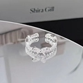 Detailed view of silver bow-shaped open ring with cubic zirconia and wavy band - Double Hollow Pave Bowknot Style (JZ3889A)