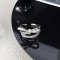 Macro shot of polished silver bow ring with shimmering cubic zirconia on black base - Pave Diamond Double Bowknot Style (JZ6079)
