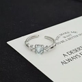 Macro detail of adjustable silver ring featuring a light blue gemstone and zircon inlay - Minimalist Blue Diamond Style (JZ3031A)