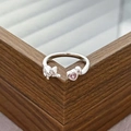 Macro shot of silver adjustable cat ring featuring a sparkling pink heart cubic zirconia - Sitting Cat Pink Heart Style (JZ1428A)