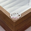 Macro shot of bow ring featuring pink zircon stones and twisted silver band details - Twisted Pearl Bow Tie Style (JZ2203A)