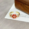 Close-up of vintage flower ring with red gemstone and white crystals on golden open band - Red Gemstone Flower With Diamonds(JZ2567A)