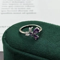 Macro shot of silver butterfly ring with purple gemstones on green velvet box - Adjustable Open / Purple Teardrop Butterfly Style (JZ2939A)