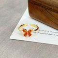Detail of vintage gold butterfly ring with orange stones and small pearls on an art card - Bright Orange Teardrop Butterfly Pearl(JZ2937A)