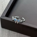 Detail of silver bow ring with blue zircon stones and twisted band design - Adjustable Open / Blue Water Drop Gemstone Style (JZ0186A)