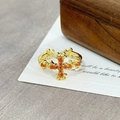 Detailed macro view of vintage gold cross ring set with vibrant orange-red zircon stones - Orange Red Gemstone Cross Carved(JZ3615A)