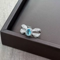 Close-up of bow ring with blue gemstone and white pavé zircon stones on stone background - Adjustable Open / Oval Blue Stone Bowknot (JZ0408A)