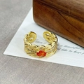 Close-up of vintage gold ring featuring orange-red gemstone and twisted texture band - Orange Red Oval Claw Entwined(JZ4592A)