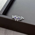 Macro detail of bow ring with purple pear-cut stones and twisted silver band - Adjustable Open / Purple Pear Gemstone Style (JZ0543A)