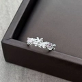 Detail of silver bow ring with pink zircon accents and rabbit motif on marble base - Adjustable Open