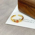 Macro view of vintage golden open ring with orange zircon and hollow floral details - Round Orange Faceted Hollow Pattern(JZ6279)