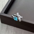 Macro detail of silver bow ring with pear-shaped blue gemstone and micro-pave crystals - Adjustable Open / Pear Aquamarine Style (JZ5054)
