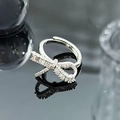 Close-up of a silver bow ring with sparkling zircons on a reflective dark surface - Delicate Micro-Inlaid Bowknot Style (JZ4978)