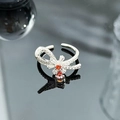 Detailed macro of a silver bow ring with orange gems and white cubic zirconia accents - Orange-Red Stone Full Zircon Bowknot Style (JZ5287)