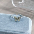 Detail of silver butterfly ring with pale yellow zircon stones on blue velvet box - Adjustable Open / Light Yellow Butterfly Style (JZ3012A)