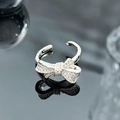 Macro shot of sparkling zircon bow ring with polished silver finish and adjustable band - Exquisite Micro-Zircon Bowknot Style (JZ6140)
