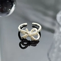 Detailed macro view of silver bow ring set with sparkling yellow cubic zirconia stones - Light Yellow Micro-Zircon Bowknot Style (JZ6204)