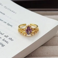 Close-up of vintage gold ring with oval purple zircon on a book page background - Adjustable Open / Vintage Palace Oval Gem Style (JZ4084A) / Gold-Purple