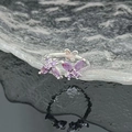 Detailed macro view of silver butterfly ring with purple zircons over water ripple surface - Purple Butterfly Silver Ring (JZ4026)