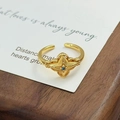 Gros plan sur une bague vintage dorée avec étoile à quatre branches et zircon bleu - Style de Pierre Bleue Starburst Vintage (JZ4596A)