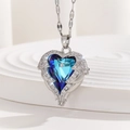 Detailed macro view of heart-shaped blue crystal pendant with silver wings and cubic zirconia - Ocean Blue Gradient Angel Wings Style (TP-04281-02)
