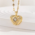 Macro detail of gold heart projection necklace with zircon stones and leaf link chain - Hollow Heart with Leaf Chain (TP-04256-01)