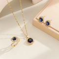 Detail of elegant gold jewelry set with deep blue round stones and crystal accents - Gold Sapphire / Number 7