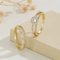 Elegant gold-plated couple ring set with micro-pave cubic zirconia on beige pedestal - US 7 / Gold