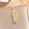 Macro shot of gold plated St Jude pendant with white zircon micro pave inlay on jewelry box - Saint Figure Pendant (TP-04371-01) / Gold