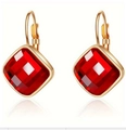 Detailed close-up of square red zircon stone set in minimalist 14K gold-plated earrings - Gold Orange Red