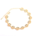 Close-up of golden smiley face bracelet with white zircons and blue stone eyes detail - Gold Bracelet Royal Blue Zirconia