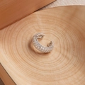 Macro view of C-shaped ear cuff with pavé-set white zircon on silver metal - Silver