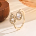 Adjustable golden ring with pear and oval shaped cubic zirconia in a pave setting - Gold Adjustable Ring