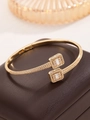 Macro detail of gold-plated bangle with square-cut cubic zirconia on leather box - Cuff Bracelet / Gold