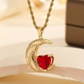 Gold twist chain necklace with sparkling crescent moon holding a red heart pendant - Red Crystal