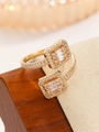 Macro shot of gold-plated open ring featuring two square zirconia gems and pavé settings - Open Ring / Gold