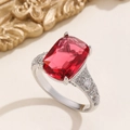 Macro shot of a rectangular red zircon ring with sparkling diamond-encrusted silver band - US 6 / Silver Rose Red