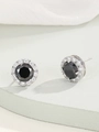 Detail view of round black glass earrings with sparkling zircon halo and silver finish - Silver Black Zirconia